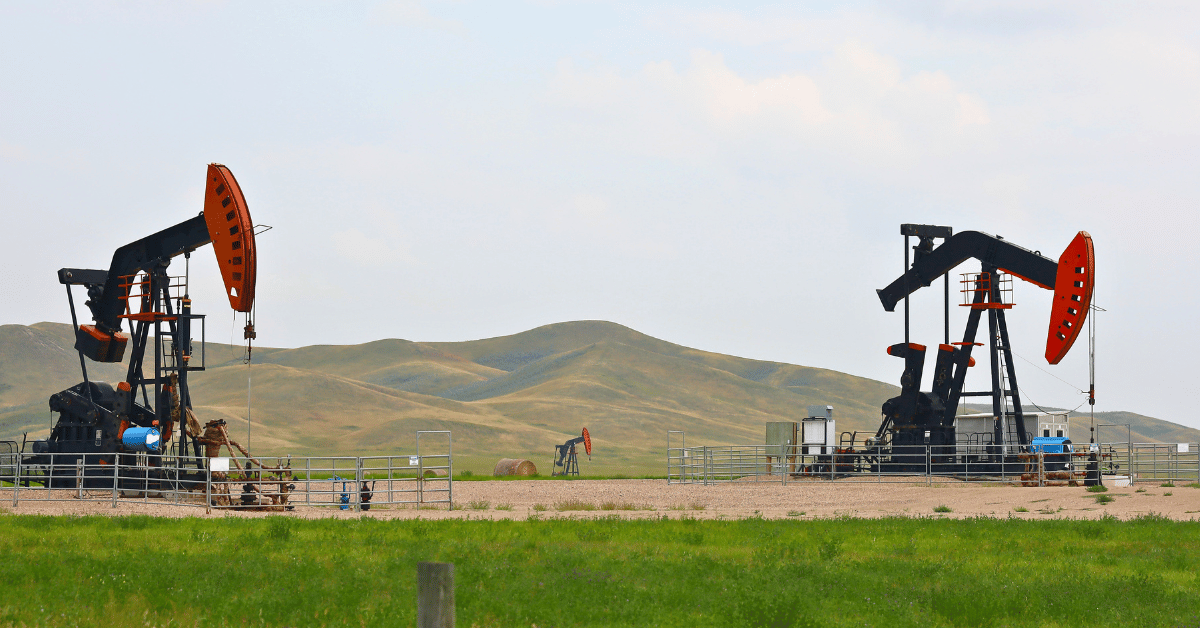 Pump jacks in grassy field